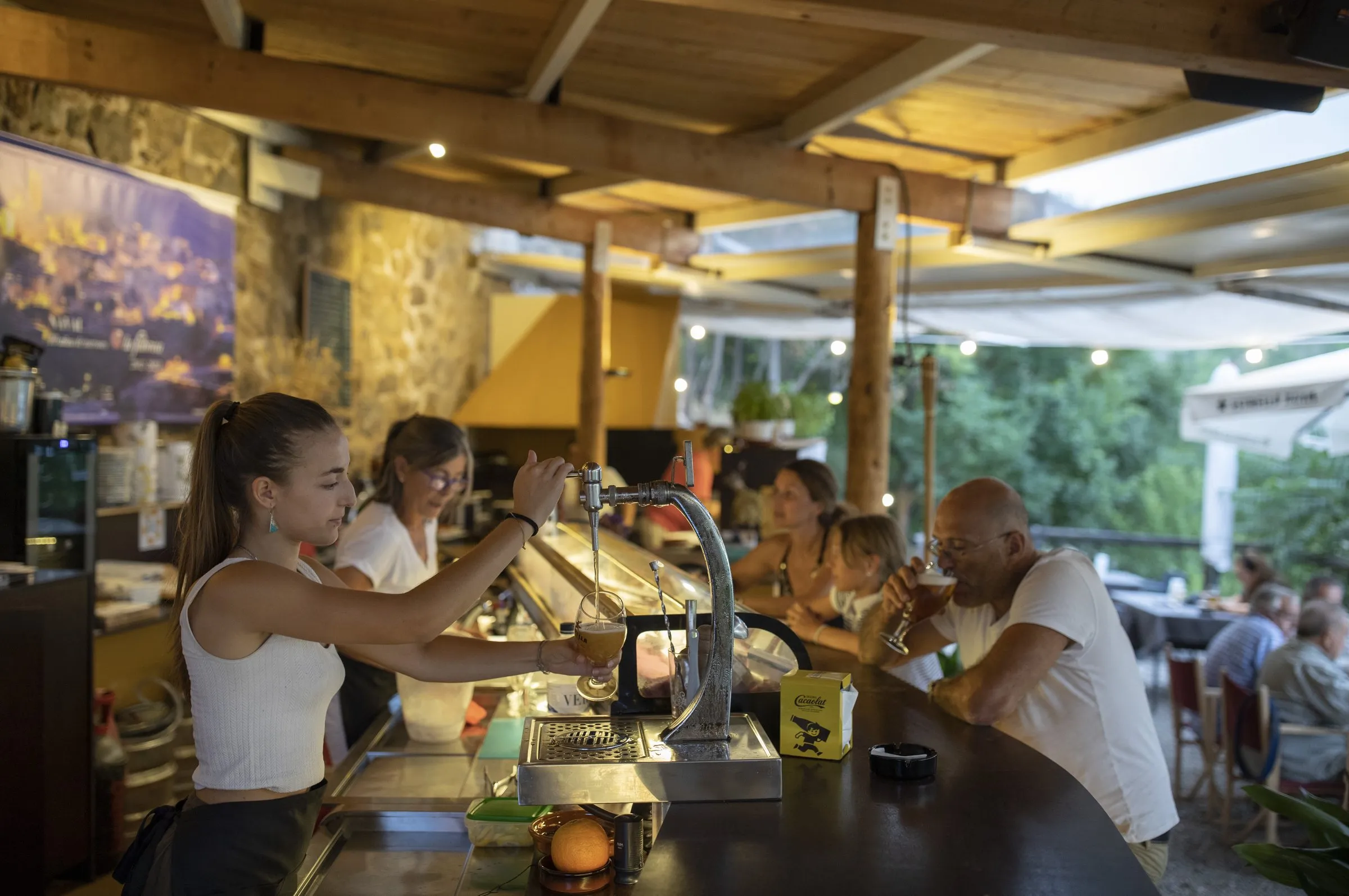 La barra llena de clientes y el equipo atendiendo